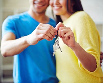 young-couple-showing-key-from-new-house